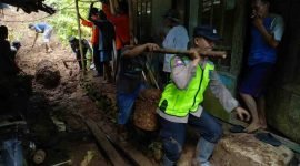 Petugas Polres Kebumen saat membantu mengevakuasi tanah longsor di rowokele.